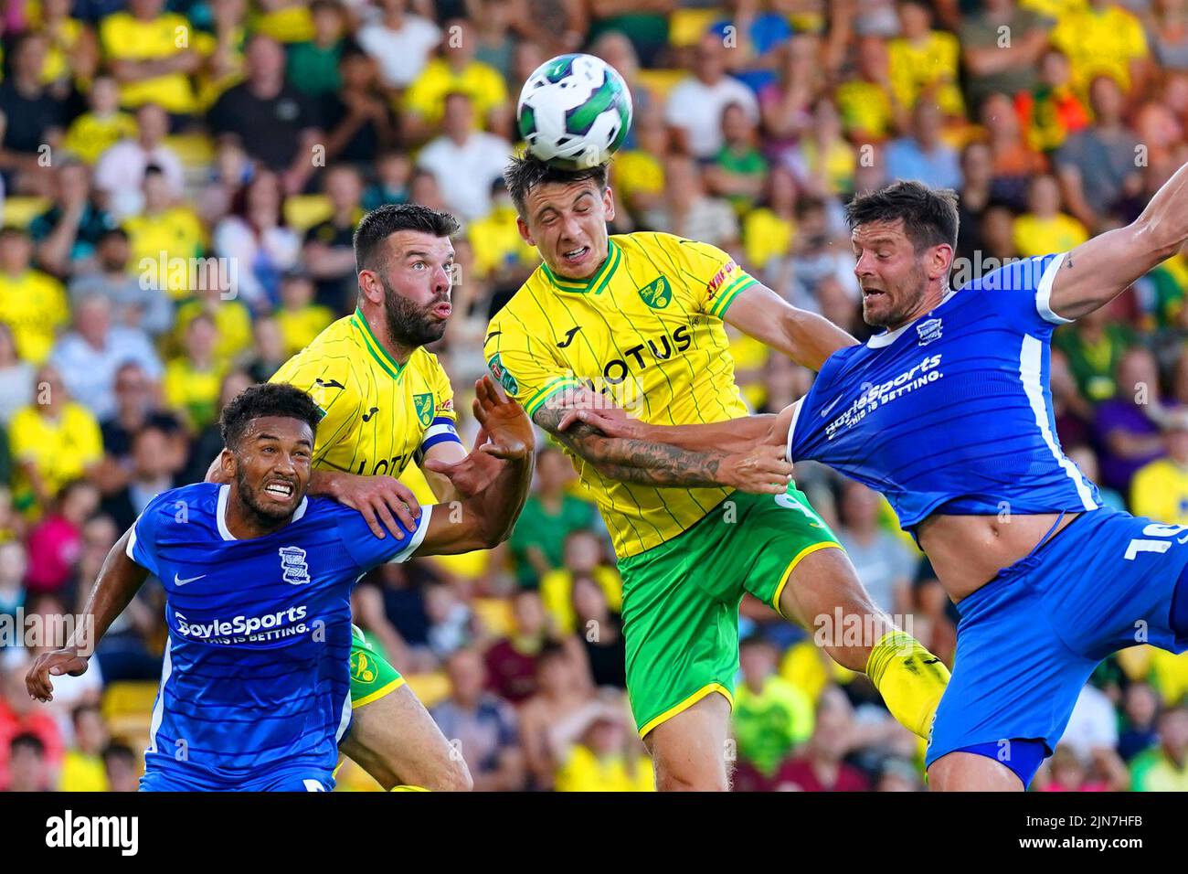 Norwich City's Jordan Hugill (centre) and Birmingham City's Lukas Jutkiewicz (right) battle for the ball during the Carabao Cup, first round match at Carrow Road, Norwich. Picture date: Tuesday August 9, 2022. Stock Photo