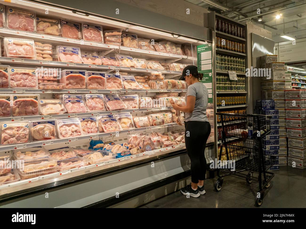A woman shops for chicken in a Whole Foods Market supermarket in New A woman shops for chicken in a Whole Foods Market supermarket in New