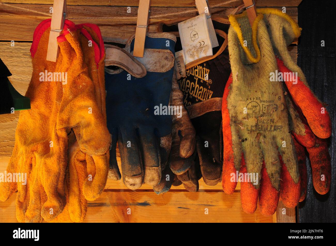 Assortment of gardening gloves pegged onto a string Stock Photo