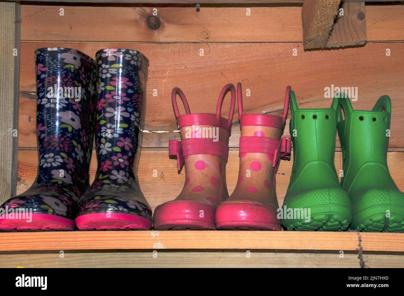 Assortment of children's wellington boots on shelf Stock Photo - Alamy