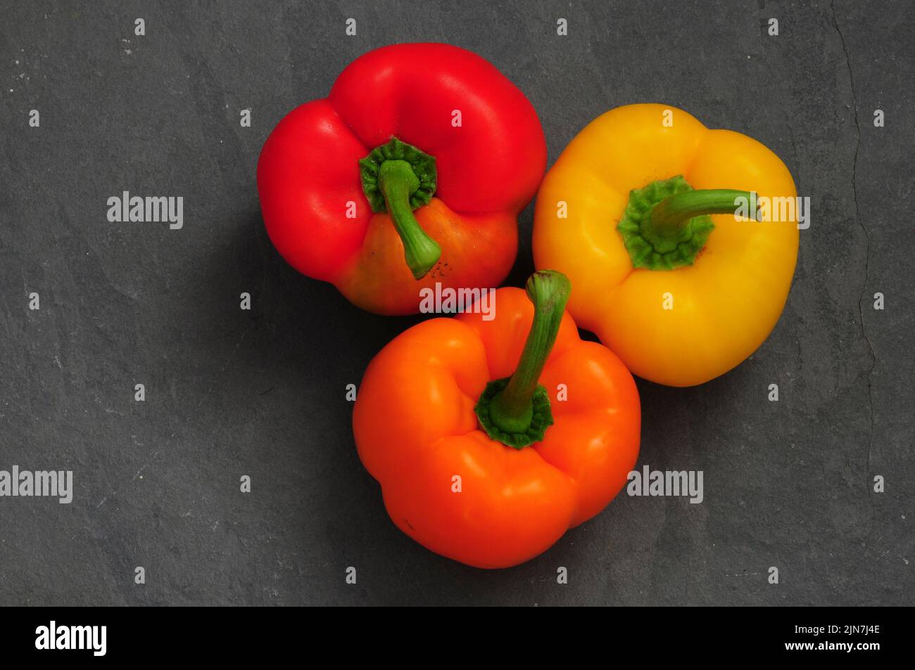 Assortment of red, orange and yellow peppers. Stock Photo