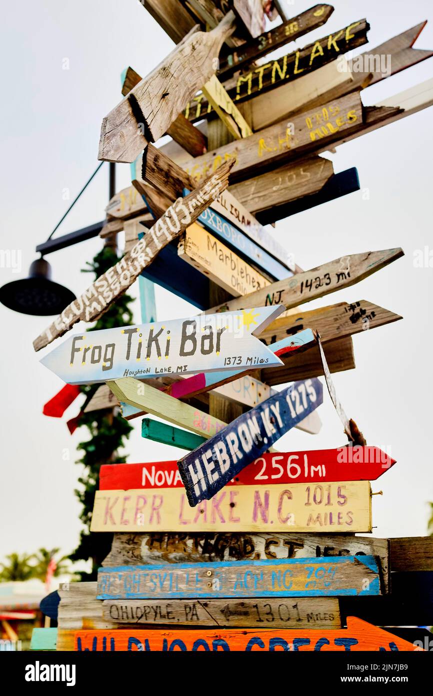 Directional sign in Key West, Florida, FL, USA.  Hand painted, hand made, directional distance arrows Stock Photo