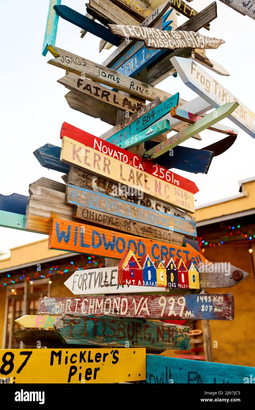 Directional sign in Key West, Florida, FL, USA.  Hand painted, hand made, directional distance arrows Stock Photo