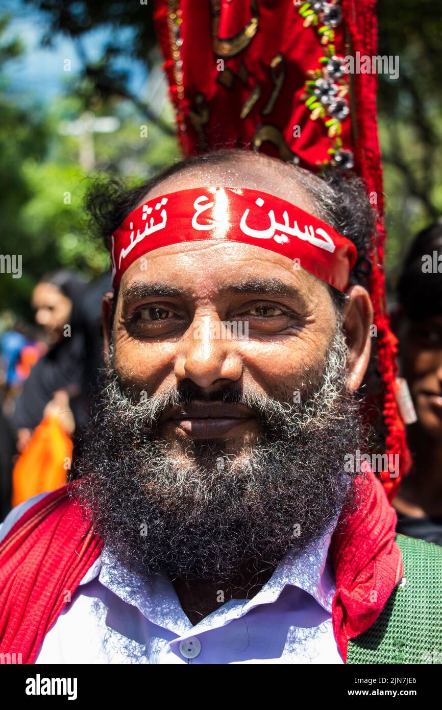 Bangladeshi Shia Muslims march and carry the flags and Tazia during a