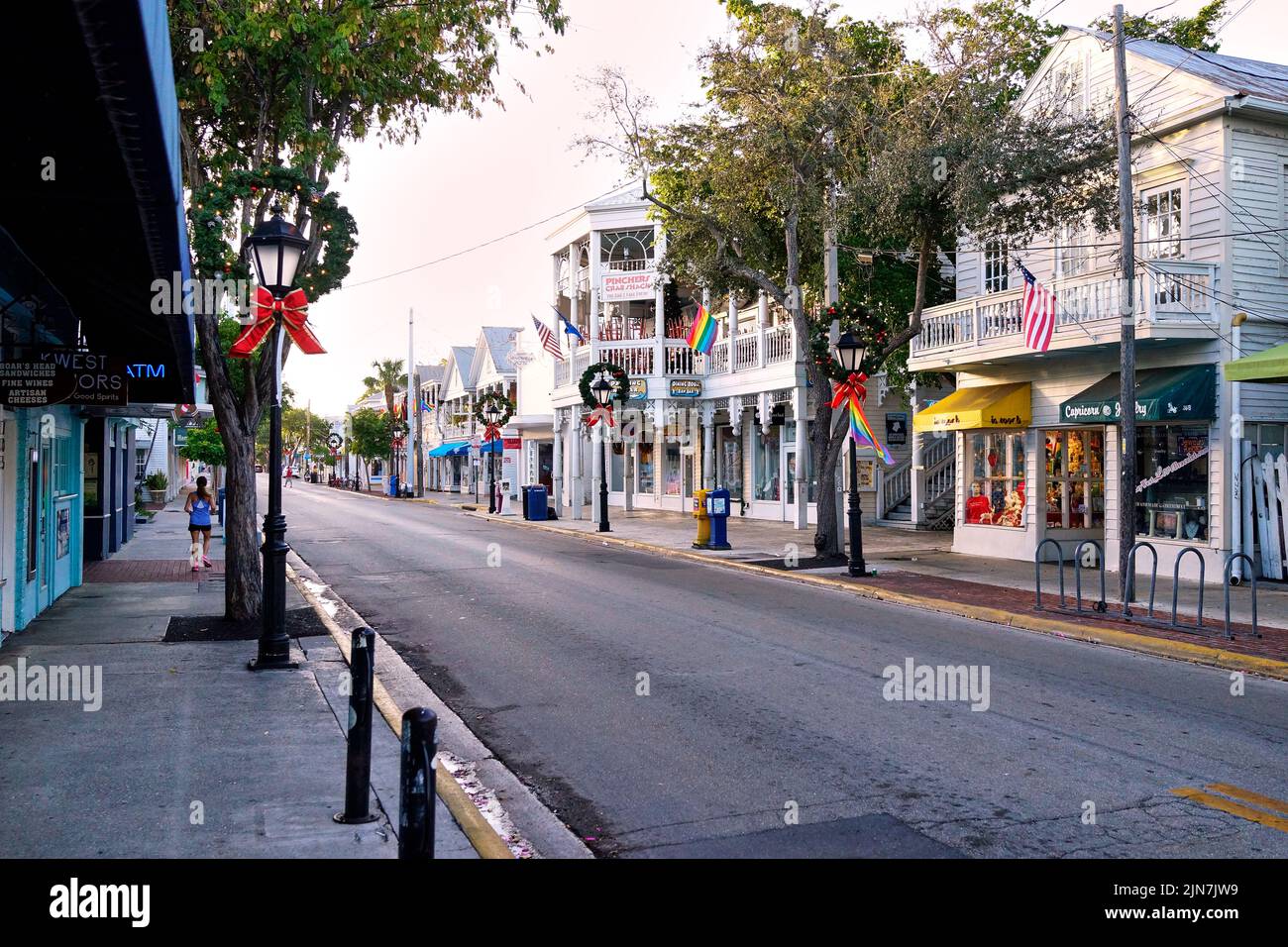 Early morning view of Duval Street in Key West, Florida, FL, USA.  Street in empty, no cars, one lonely jogger Stock Photo