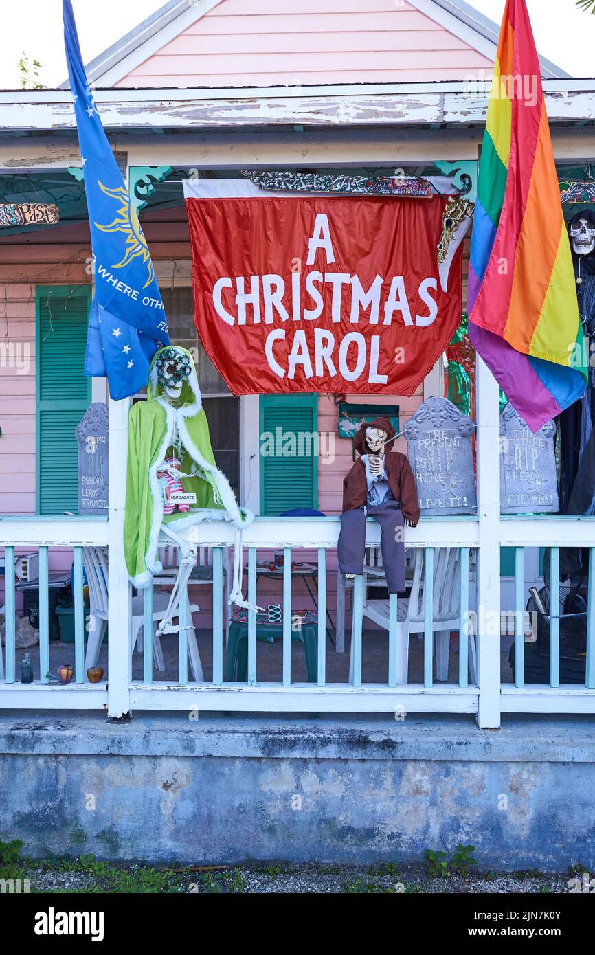 A Christmas Carol display in Key West, Florida, FL, USA.  With skeletons and flags on porch of Conch house.  Pride & Conch Republic flags. Stock Photo