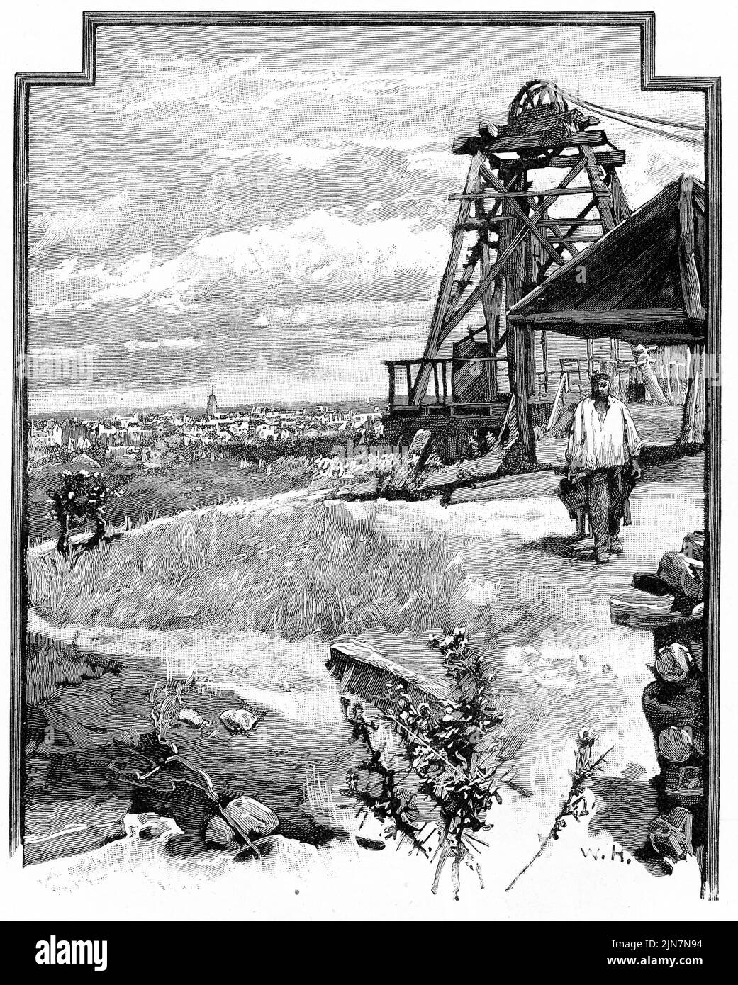 Engraving of a poppet head of a gold mine overlooking a mining town Stock Photo