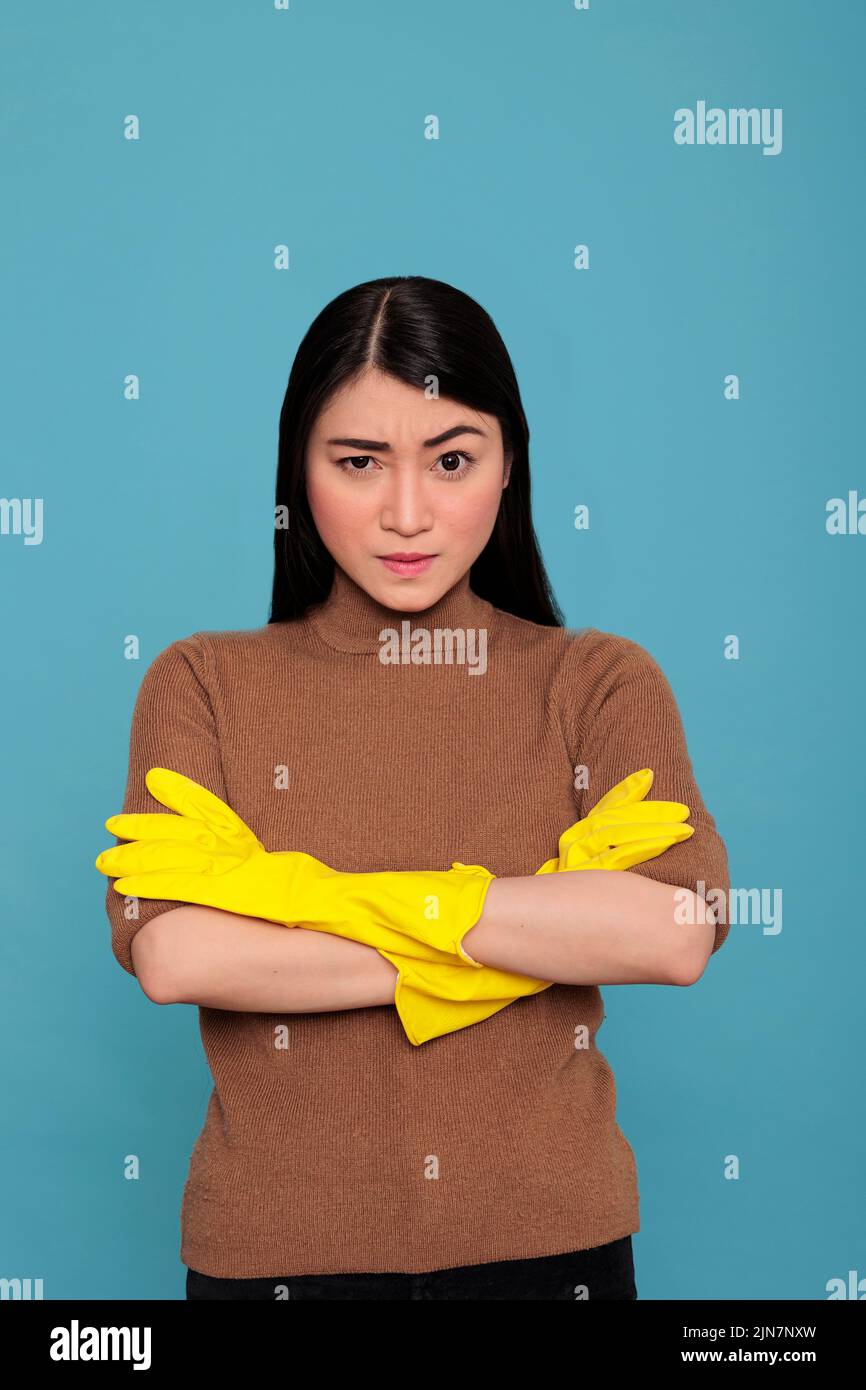 Asian tired angry and frustrated asian housekeeper at work wearing ...