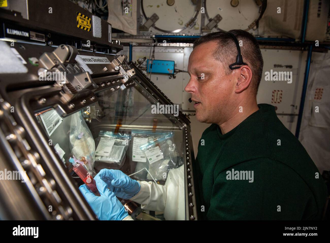 Earth Atmosphere. 19th July, 2022. Astronaut Bob Hines processes biology samples and explores the immunological aging of cells in weightlessness. Credit: NASA/ZUMA Press Wire Service/ZUMAPRESS.com/Alamy Live News Stock Photo