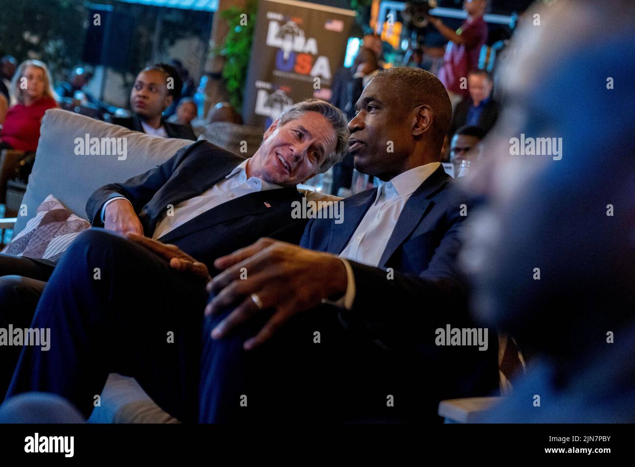U.S. Secretary of State Antony Blinken and former NBA basketball superstar and Congo native Dikembe Mutombo speak together as they watch the 'Rainbow Band' perform at Villa Kilimanjaro in Kinshasa, Congo, August 9, 2022. Andrew Harnik/Pool via REUTERS Stock Photo