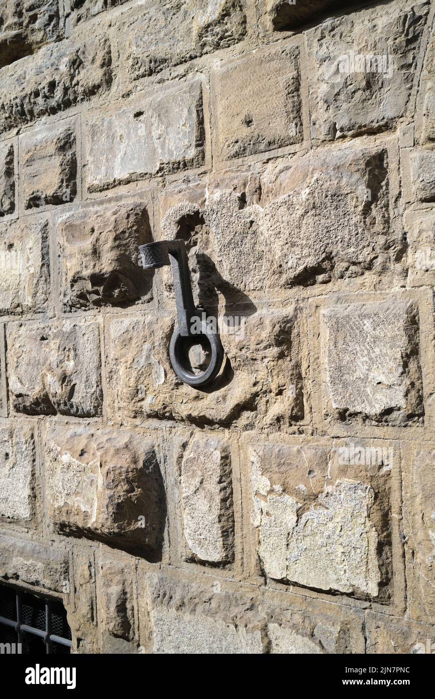 Cast Iron Torch Holders and Horse Tethers on the exterior of an historic building in Florence Italy Stock Photo