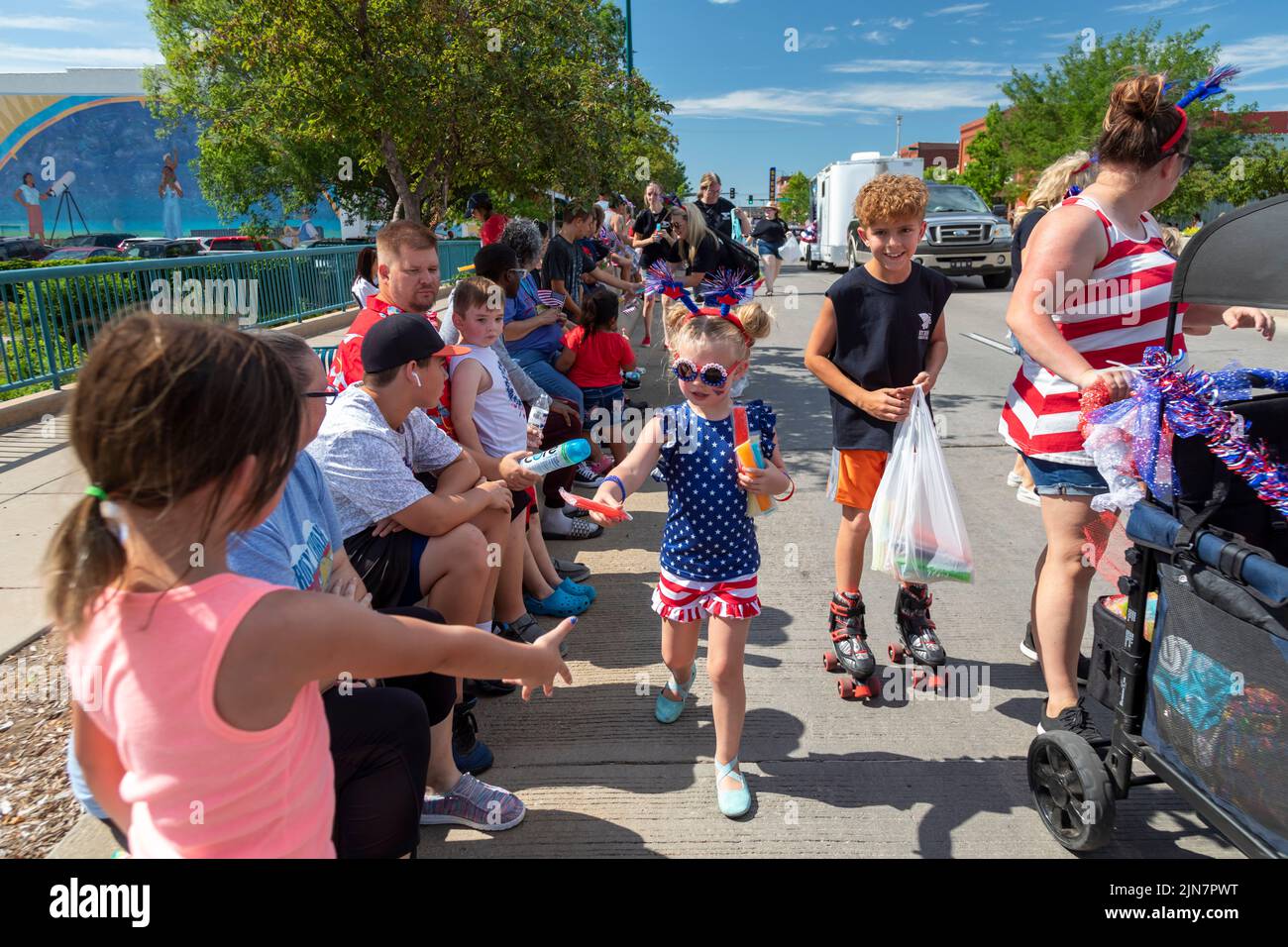 Hutchinson, Kansas - A girl hands out treats during the annual July 4 'Patriots Parade' in rural Kansas. Stock Photo