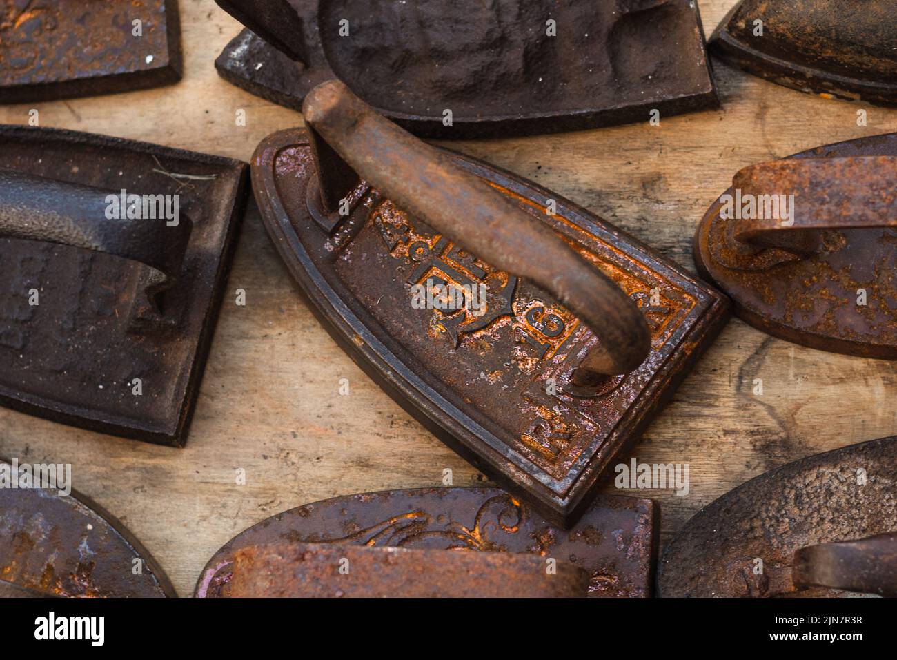 Set of rusty cast iron and steel irons on a flea market Stock Photo Alamy