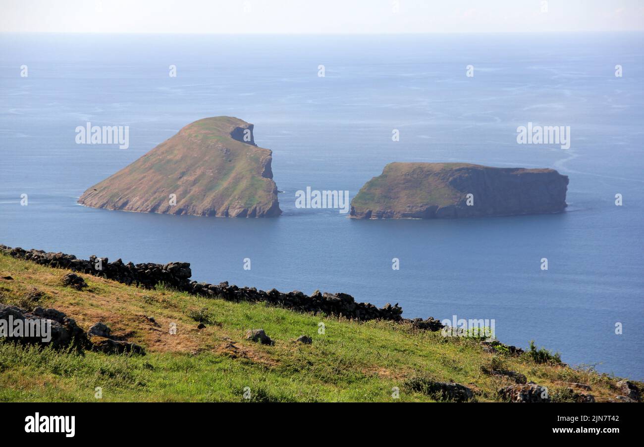 Rural landscape, pastures and stone fences, sloping to the ocean coast, view from Serra da Ribeirinha, with Cabras Islets off shore, Terceira, Azores Stock Photo
