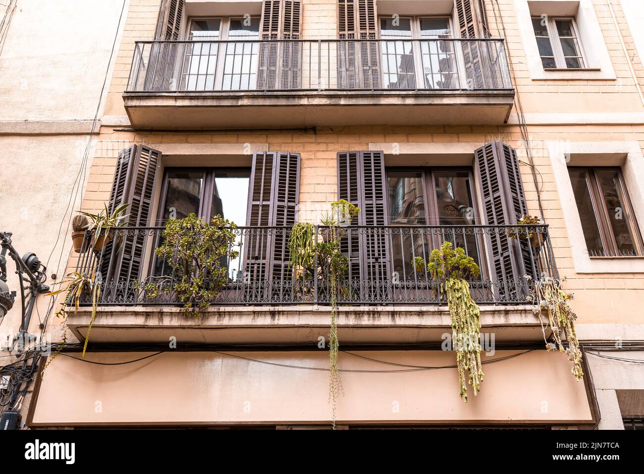Building On Rails Exterior of apartment building with balconies and plants on the rails ...