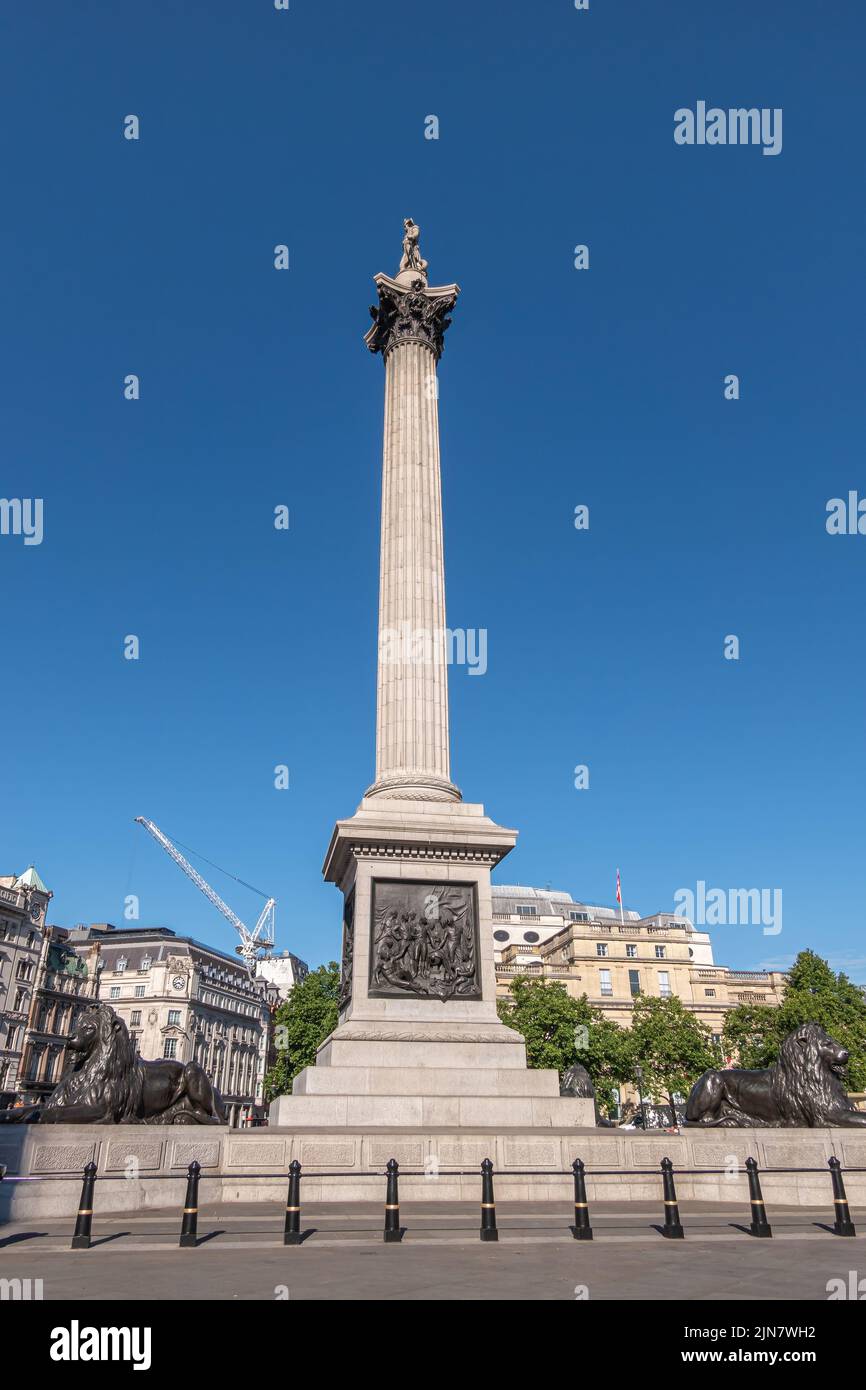 London, UK- July 4, 2022: Trafalgar Square. East side of Nelson's Column against blue sky showing High Commission of Canada with its flag in the back. Stock Photo