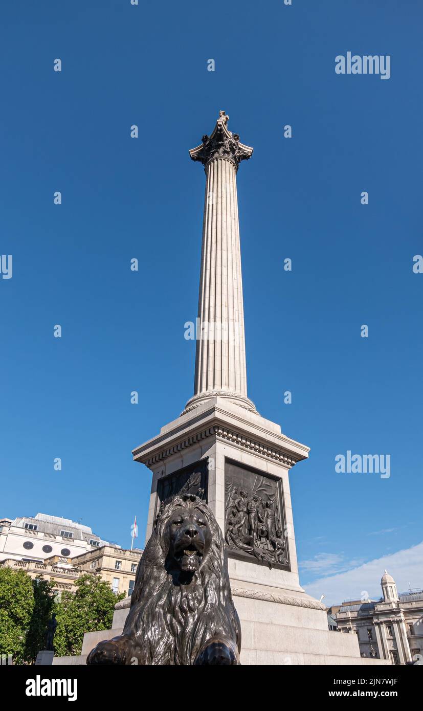 London, UK- July 4, 2022: Trafalgar Square. Fish eye perspective on Nelson's Column against blue sky showing High Commission of Canada with its flag i Stock Photo