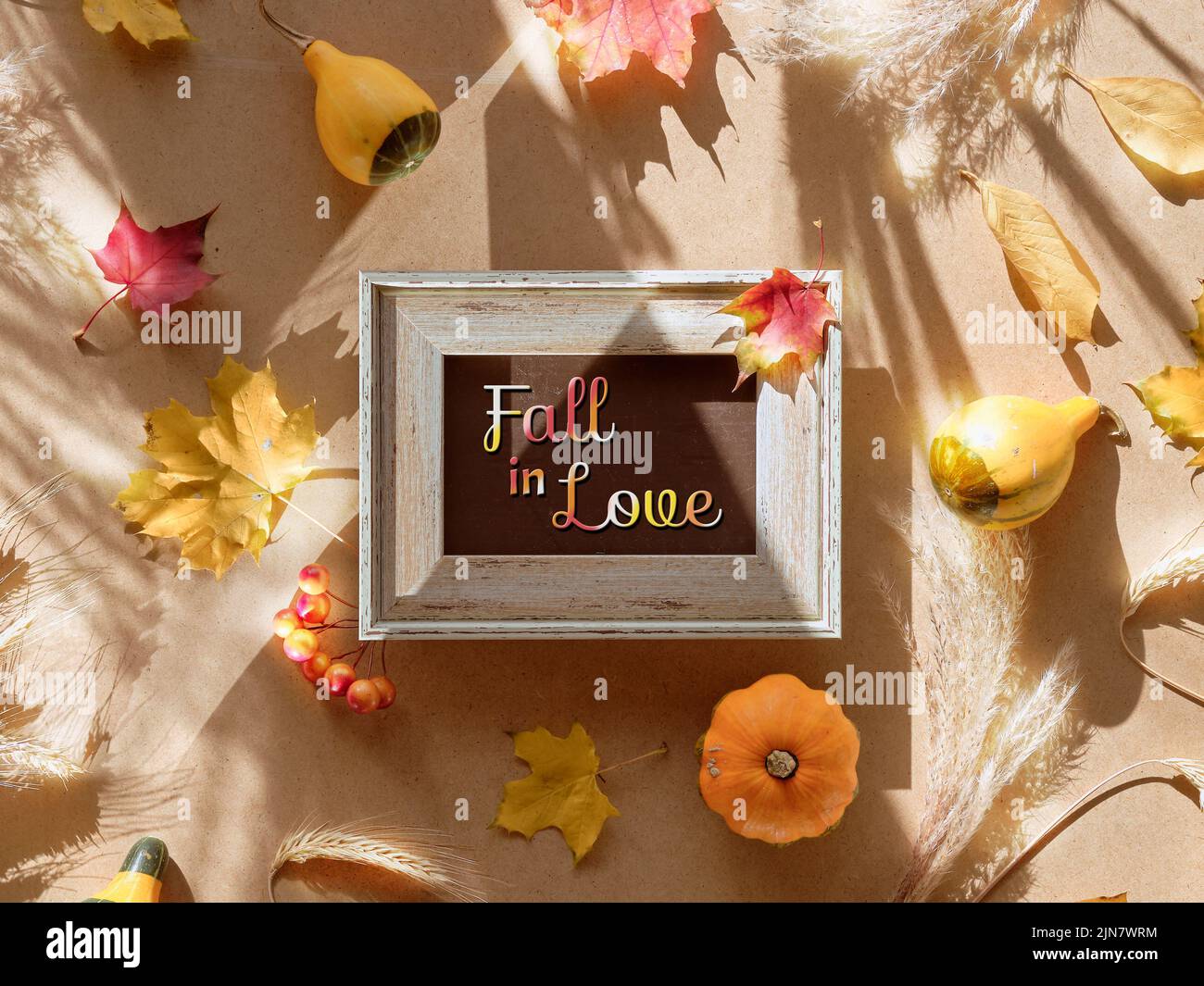 Autumn frame, caption greeting text Fall in Love. Natural Fall leaves