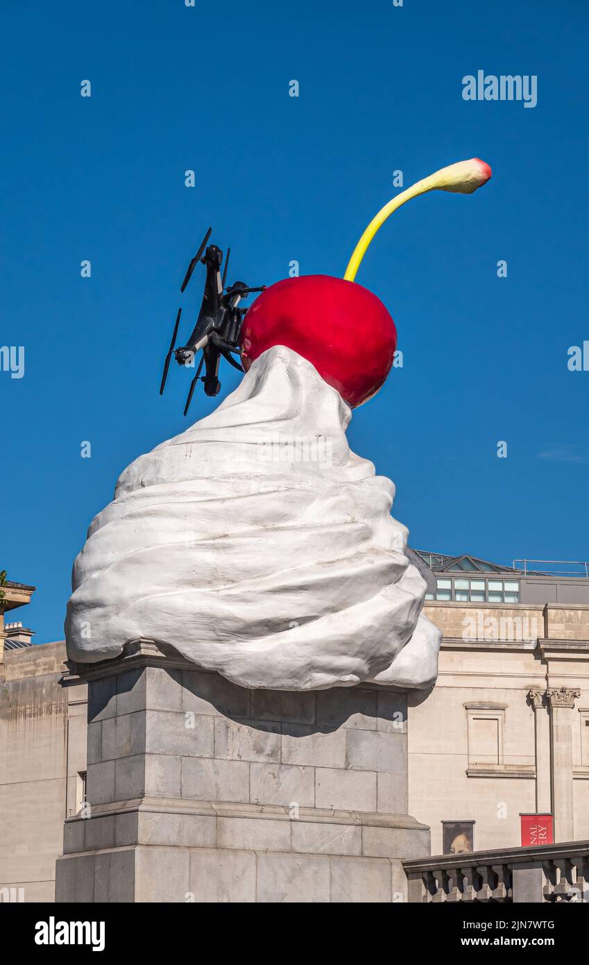 London, UK- July 4, 2022: Trafalgar Square. Closeup of Whipped Cream With red Cherry on top statue, named The End, against blue sky. National Gallery Stock Photo