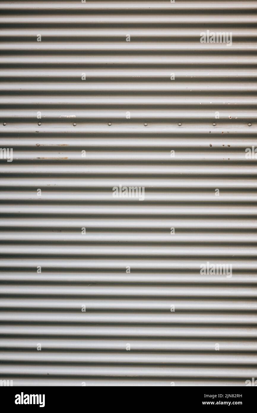 A vertical shot of a closed metal roll-up door of a store Stock Photo