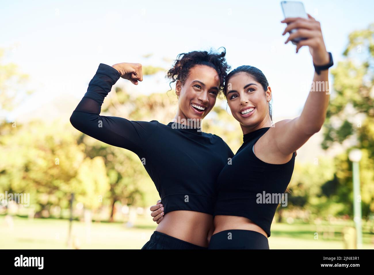 We made it. Cropped portrait of two attractive young women posing for a selfie after their run together in the park. Stock Photo