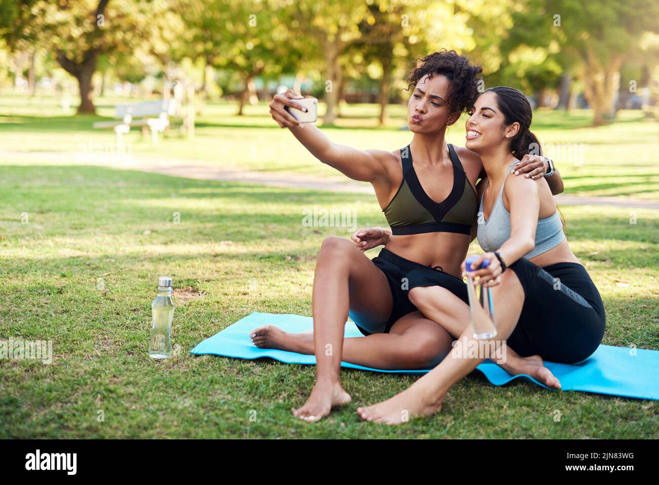 Duckface Do the duckface. Full length shot of two attractive young women posing for a selfie while in the park during the day. Stock Photo
