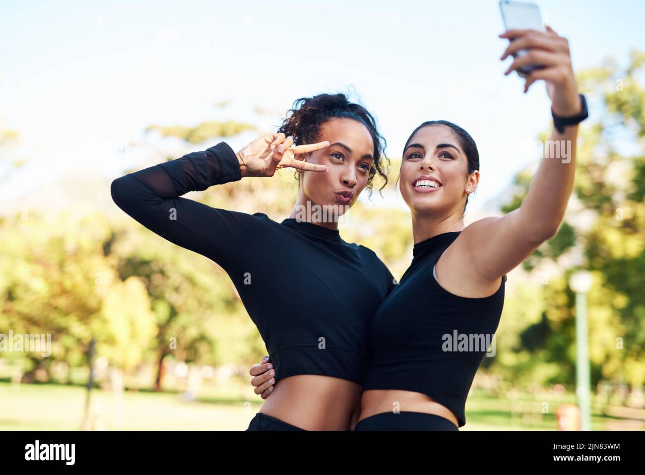 Were collecting moments, not things. Cropped portrait of two attractive young women posing for a selfie after their run together in the park. Stock Photo