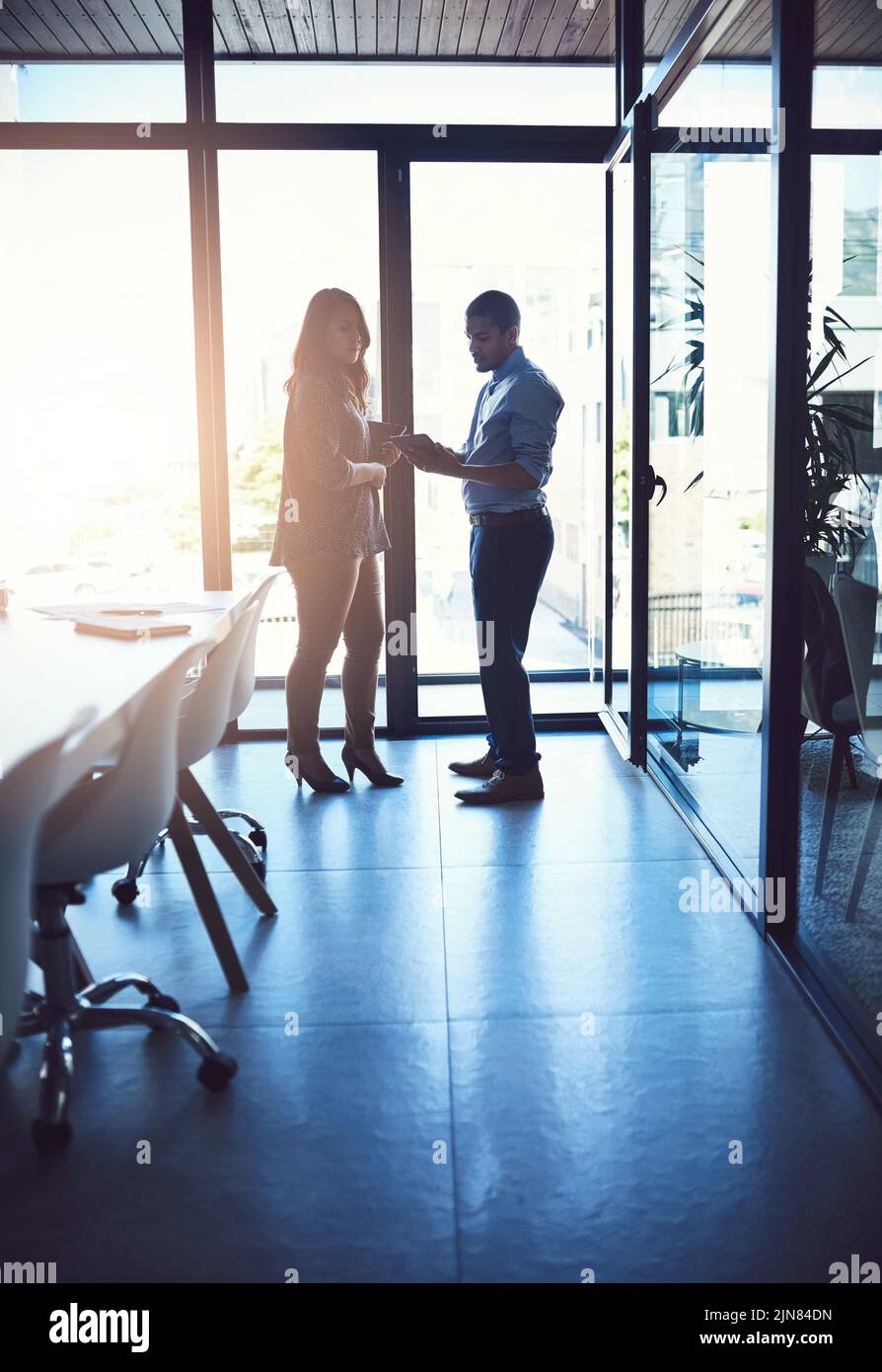 Business people or professional managers talking about project management, discussing schedule and planning. Young businessman and businesswoman Stock Photo