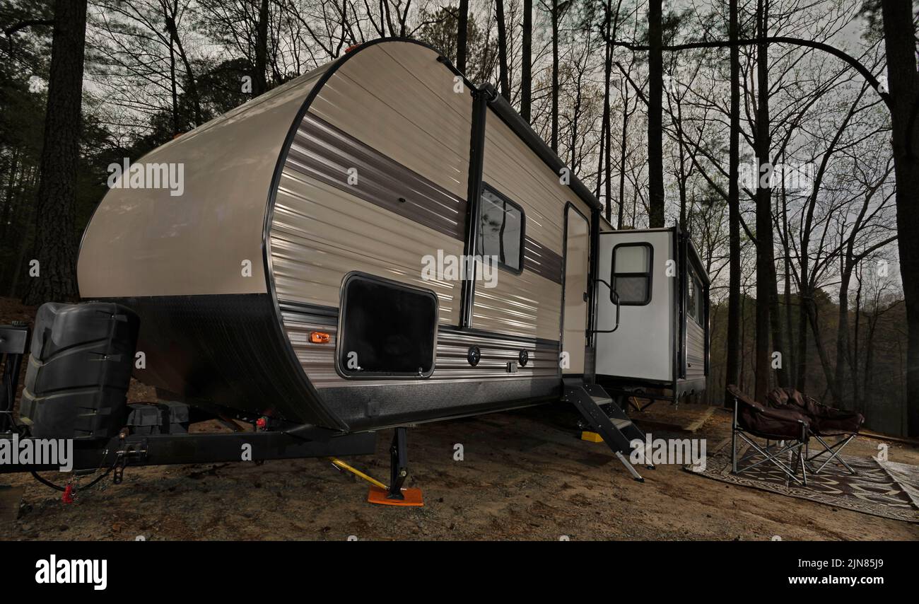Bumper pull trailer at a campsite in North Carolina as the sun sets Stock Photo