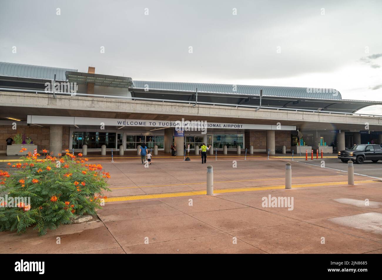 Travelers and passengers in front of Tucson airport terminal.  Stock Photo
