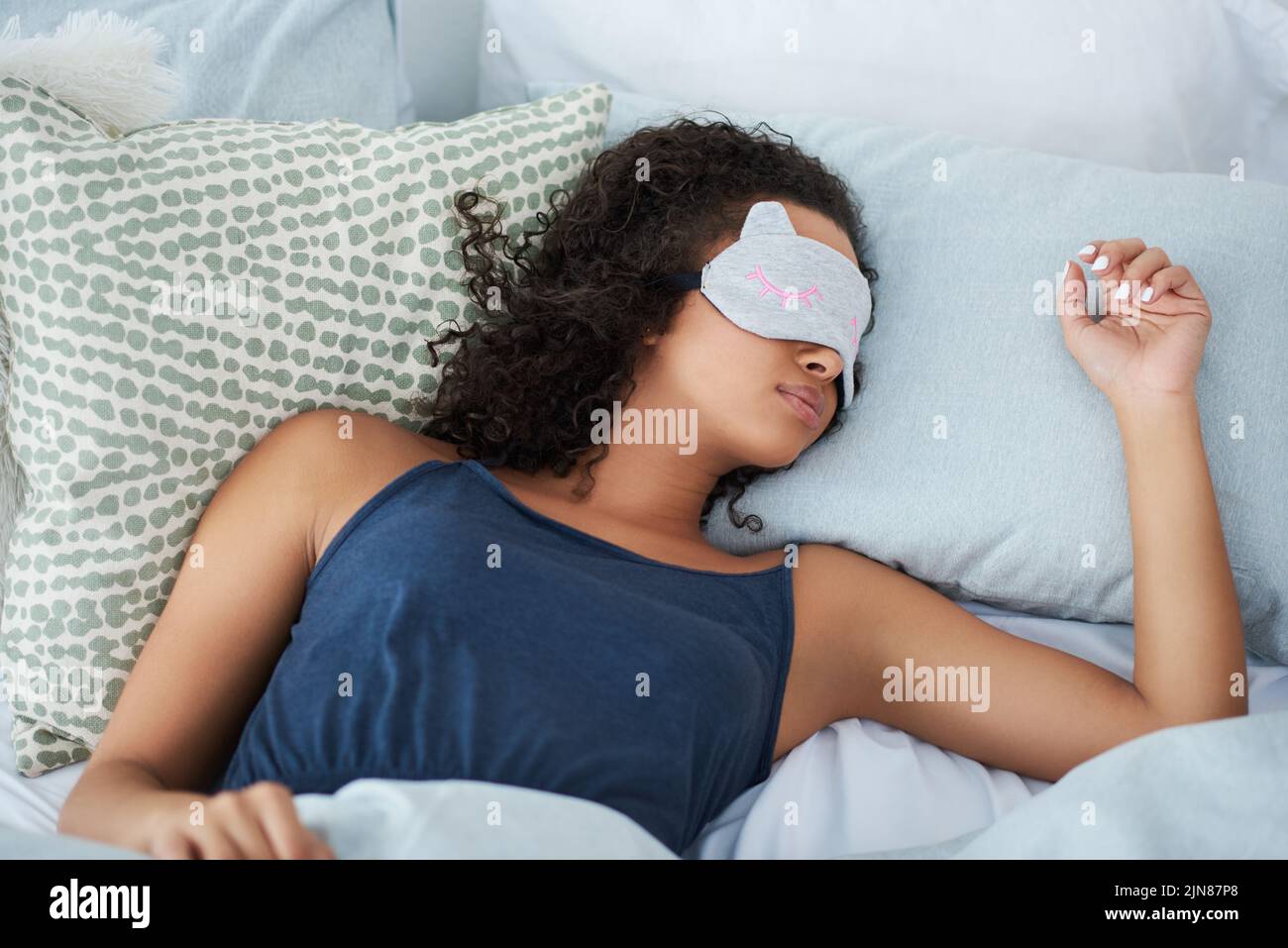 I sleep better with my eye mask on. an attractive young woman sleeping