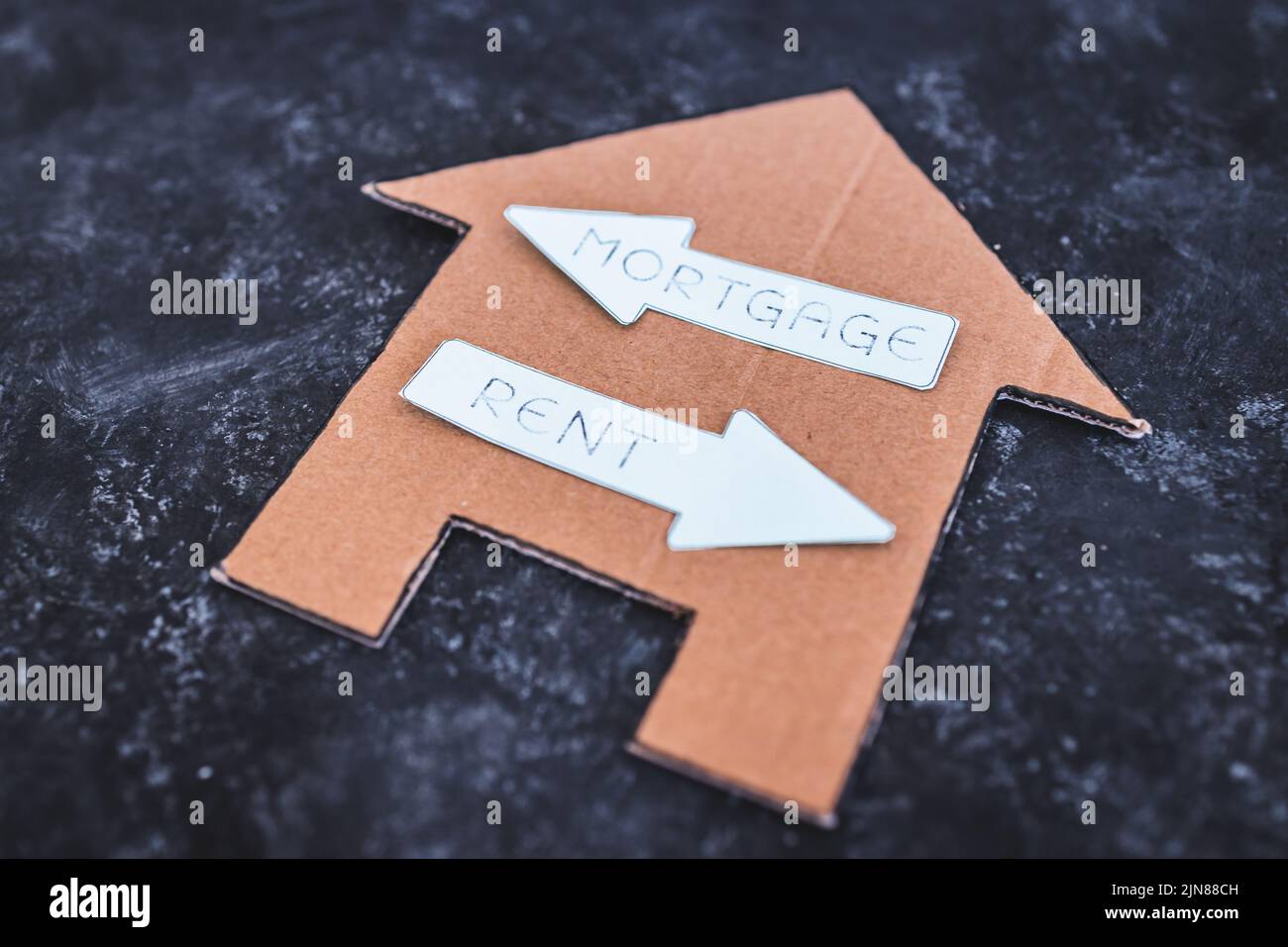 house icon with mortgage or rent signs pointing in opposite directions