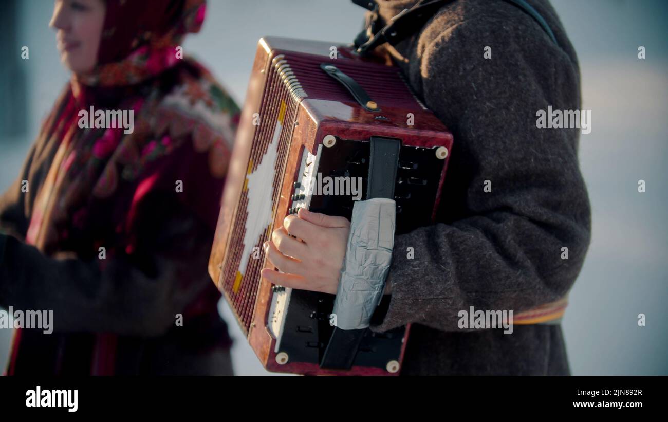 Russian folklore russian man playing accordion outdoors Stock Photo