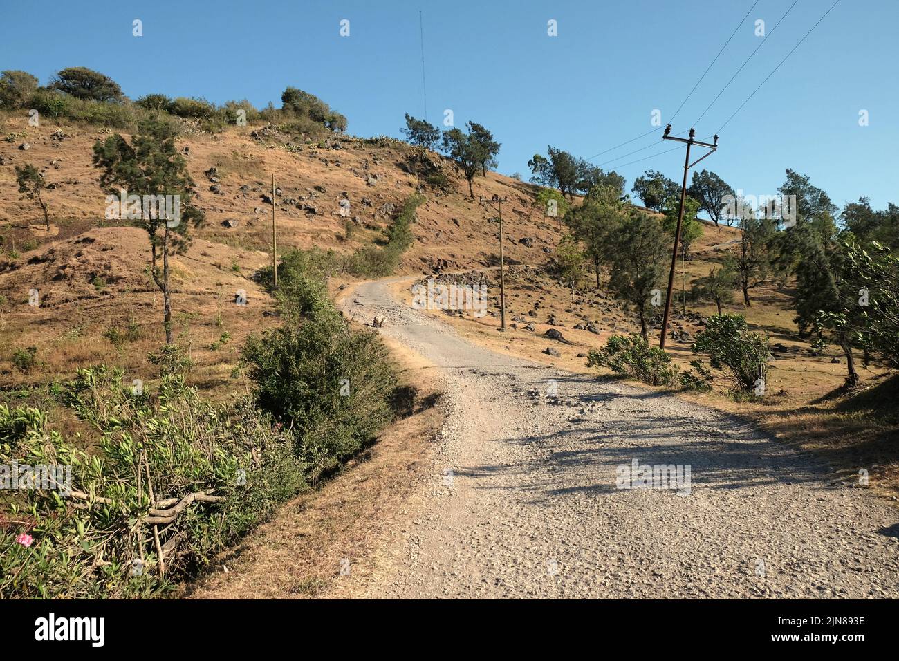 View of a mountain road connecting Soe and Fatumnasi in South Central Timor, East Nusa Tenggara, Indonesia. Stock Photo