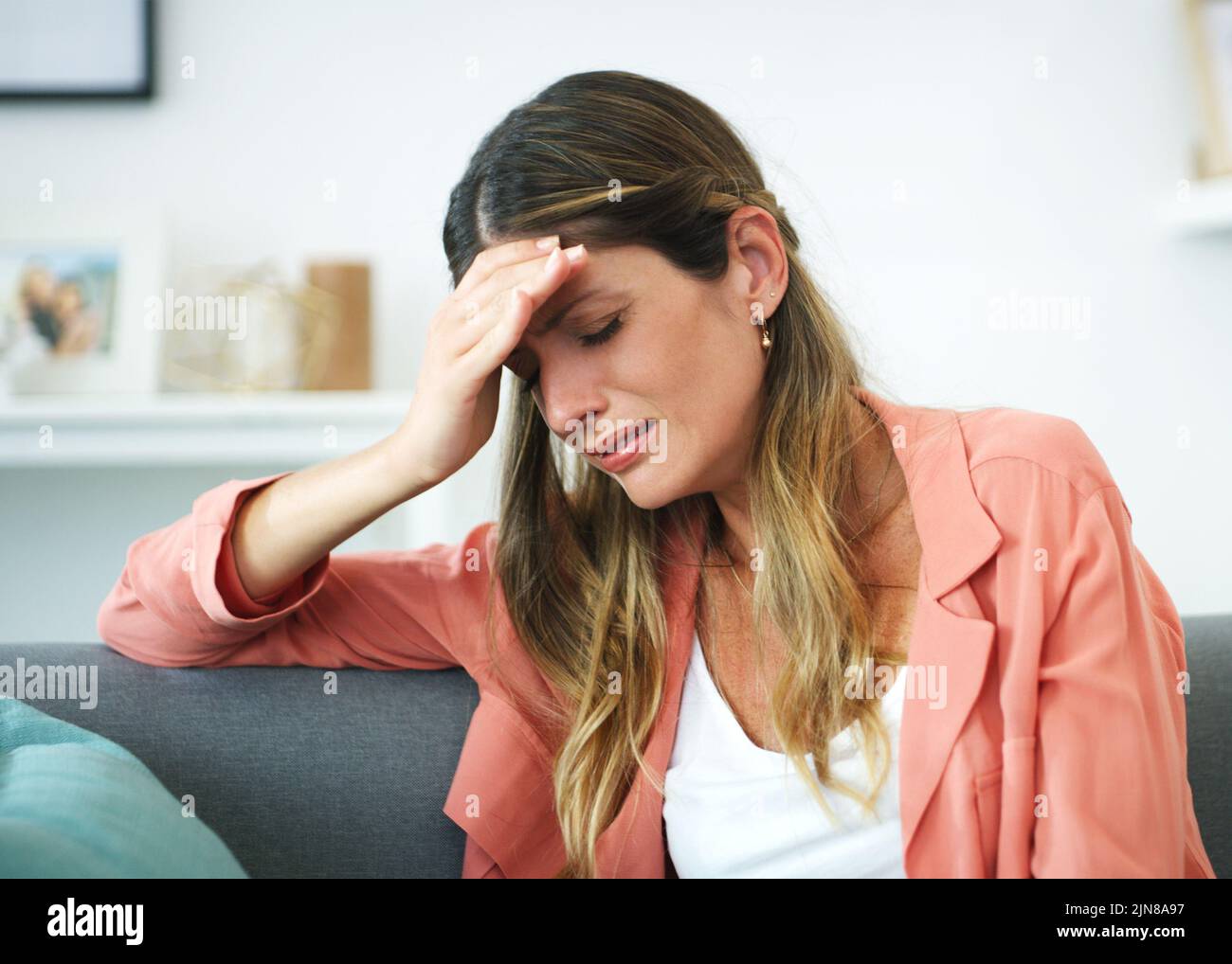 I cant take it anymore. an attractive woman crying at home. Stock Photo
