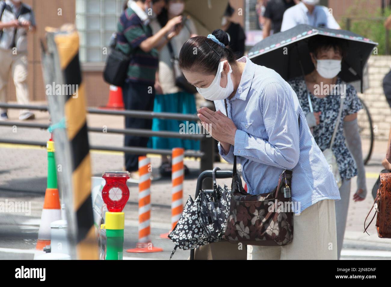 People pray at the site where late former Japan's Prime Minister Shinzo Abe was shot near Yamato-Saidaiji station in Nara-Prefecture, Japan on August 8, 2022. Credit: AFLO/Alamy Live News Stock Photo