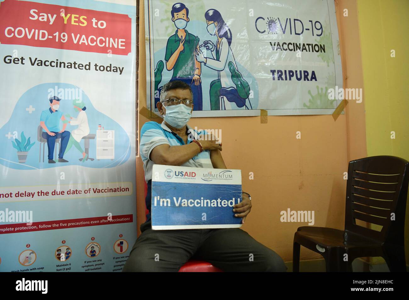 A health worker administers the third dose (Booster Dose) of COVID-19 vaccine to a person, at the Tripura Wholesale grocery Merchants Association in Agartala. Tripura, India. Stock Photo