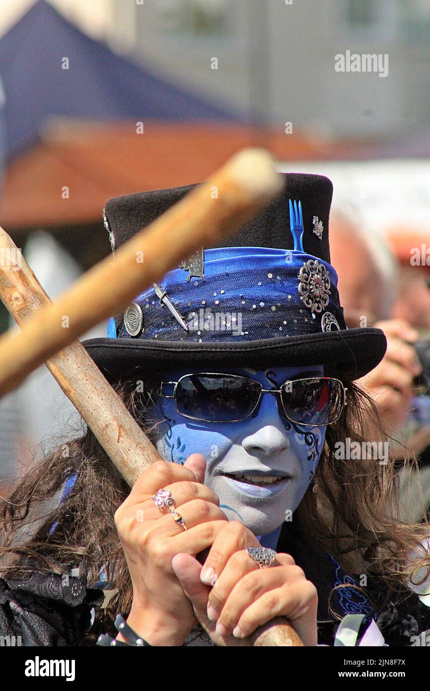 SIDMOUTH, DEVON, UK - AUGUST 8, 2017 Sidmouth Folk Festival performers from Boggart's Breakfast with painted blue faces and black clothes Stock Photo