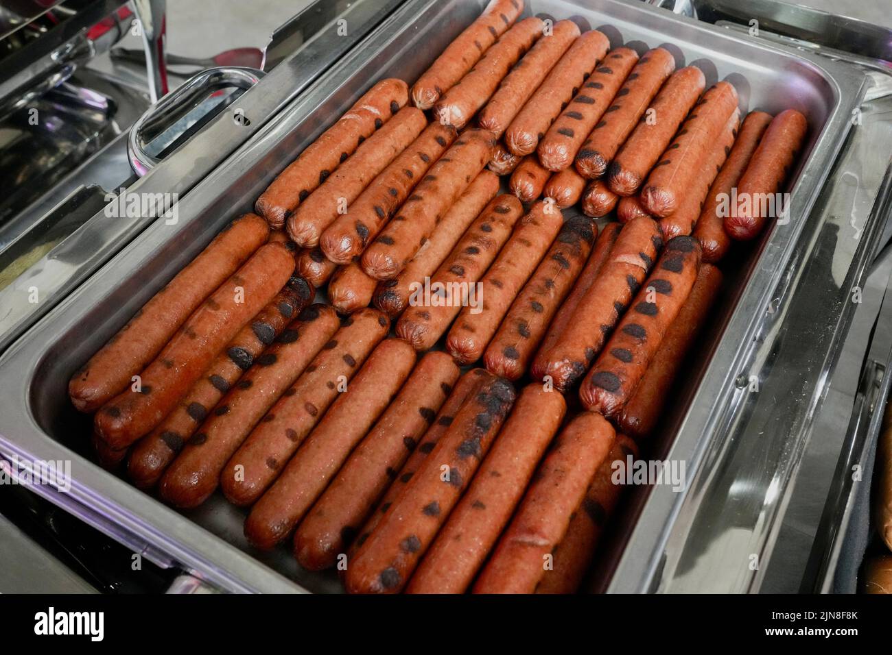A group of hot dogs in a tray at a buffet. Stock Photo