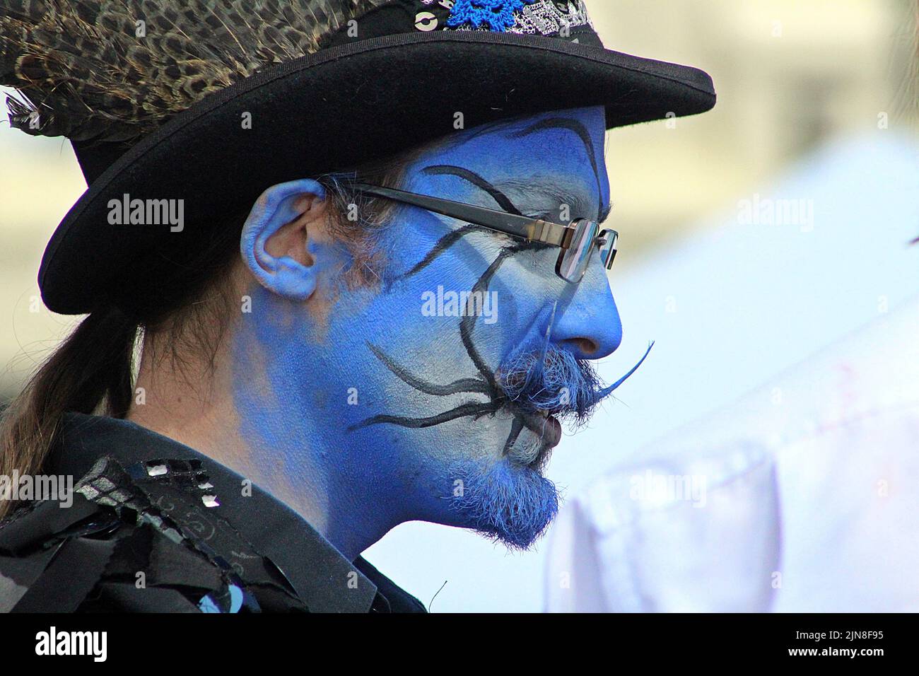 SIDMOUTH, DEVON, UK - AUGUST 8, 2017 Sidmouth Folk Festival performers from Boggart's Breakfast with painted blue faces and black clothes Stock Photo