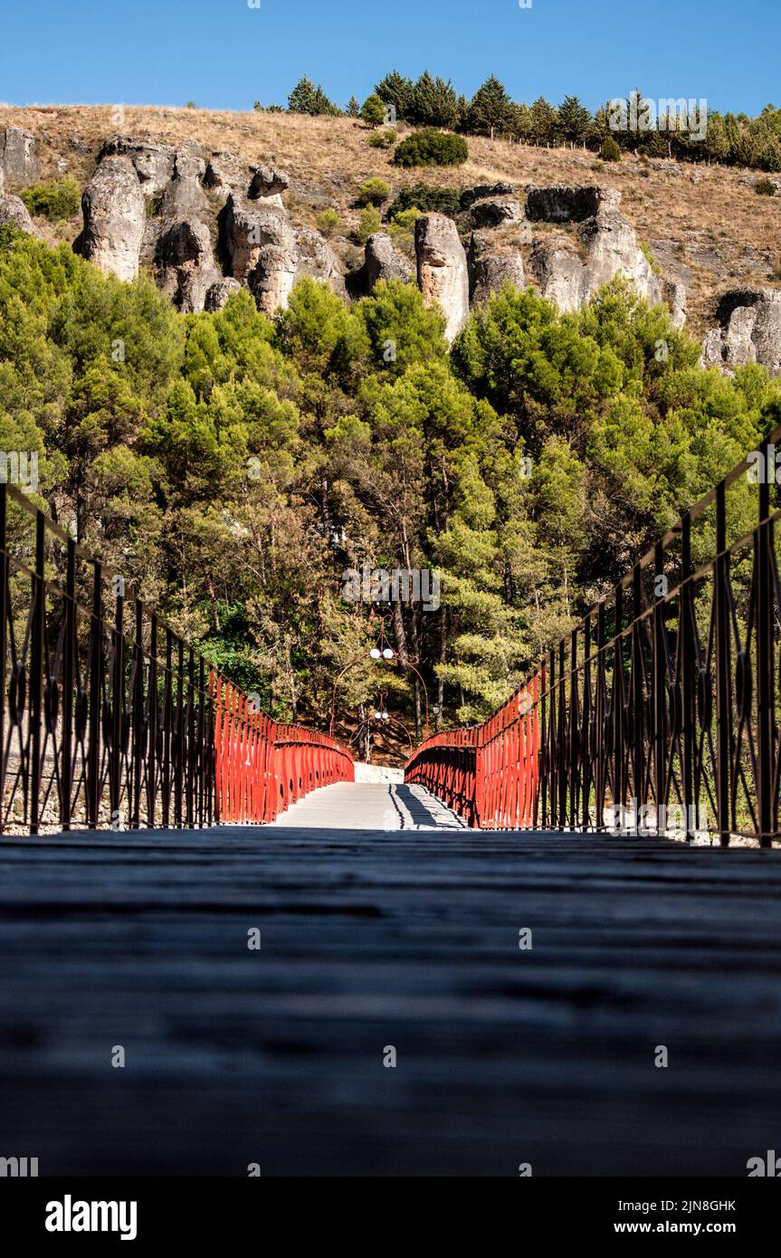 Red bridge in front of the hanging houses of Cuenca, Spain Stock Photo ...