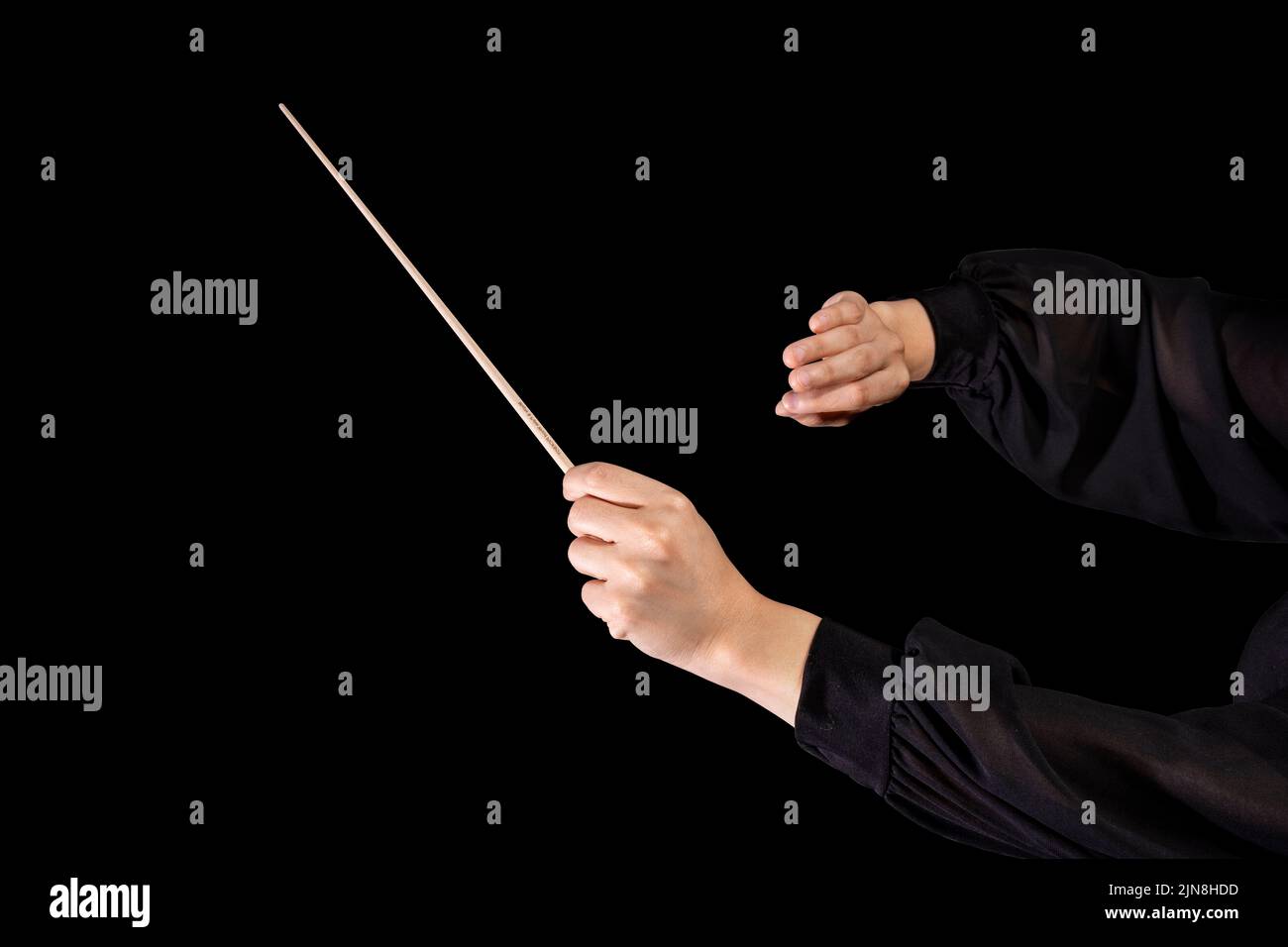 Female conductor conducting a symphony with her baton on a black background Stock Photo Alamy
