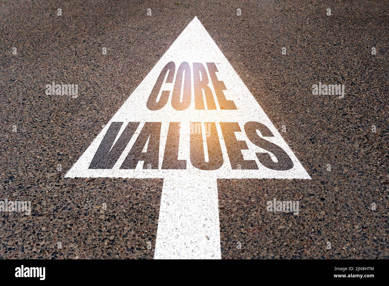 Business concept. On the asphalt road markings an arrow with the inscription CORE VALUES Stock