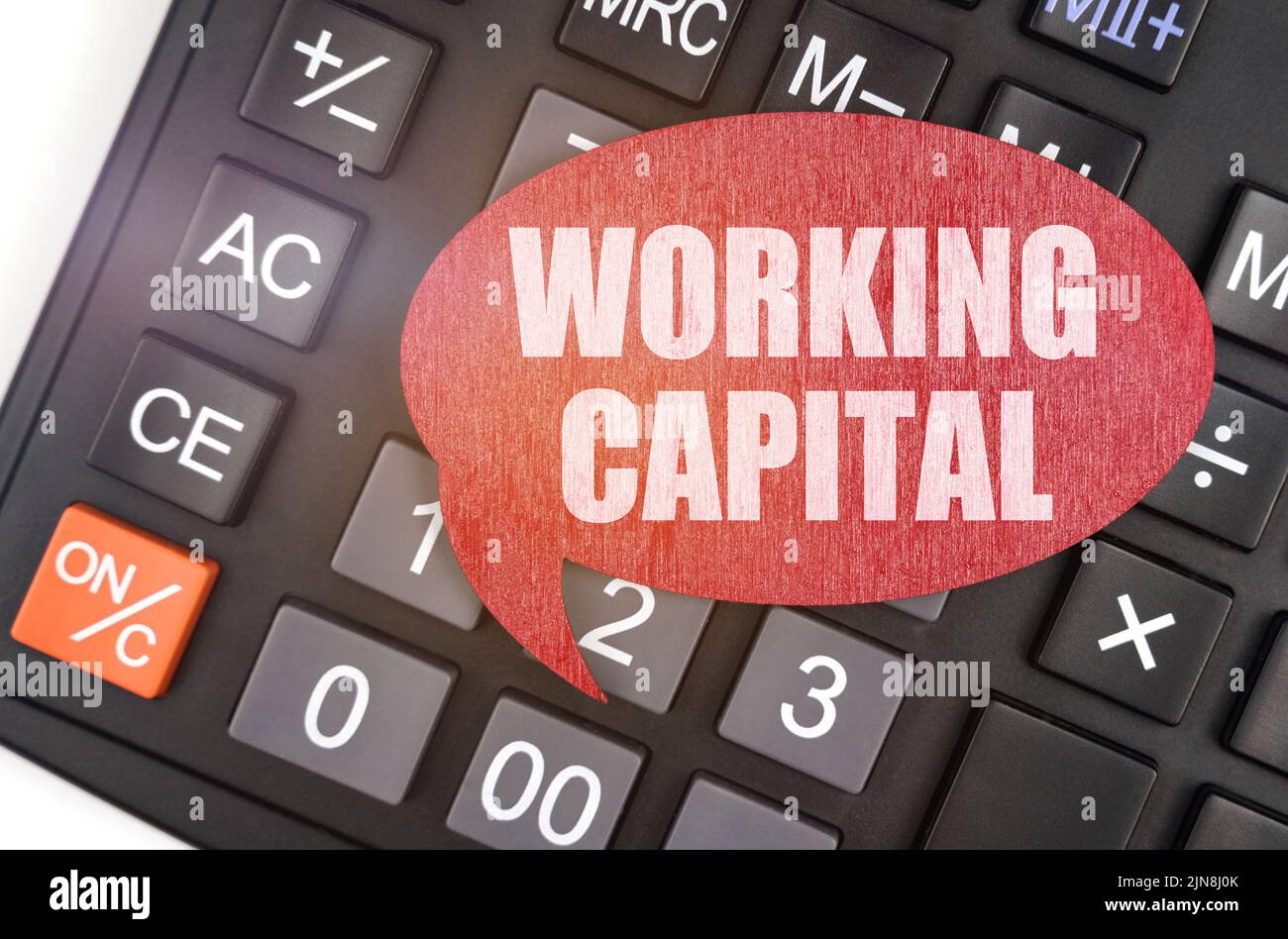 Business and finance concept. There is a red plaque on the calculator that says - WORKING CAPITAL Stock Photo