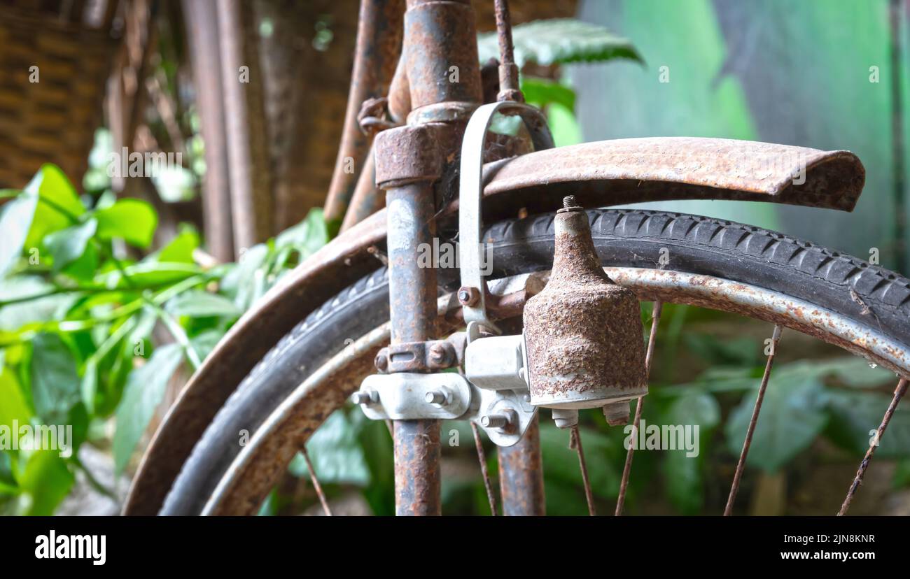 Old bicycle found in nature, selective focus on dynamo Stock Photo