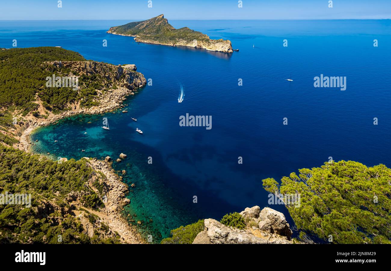 High angle view of the cozy bay Cala en Basset nearby the village Sant Elm at the most west side of Mallorca with anchored boats and island. Stock Photo