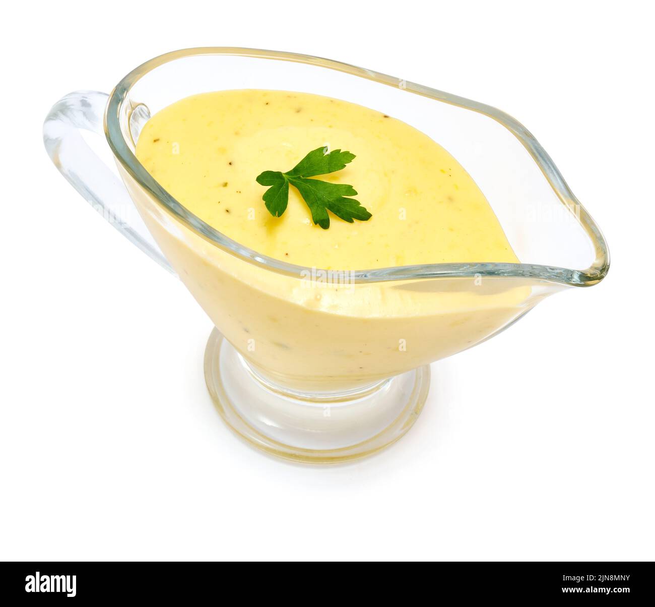 Tasty yellow hollandaise sauce in glass bowl gravy boat isolated on