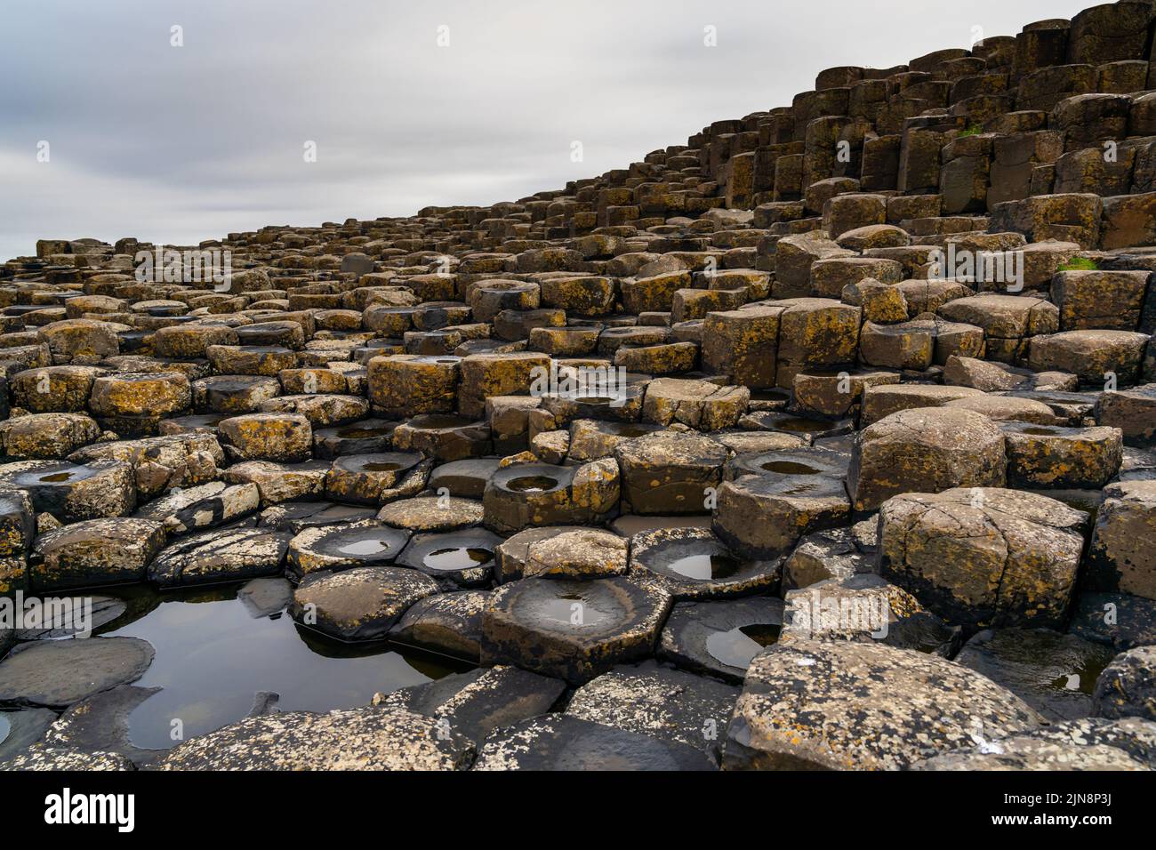 A view of the many volcanic basalt columns of the Giant's Causeway in Northern Ireland Stock Photo