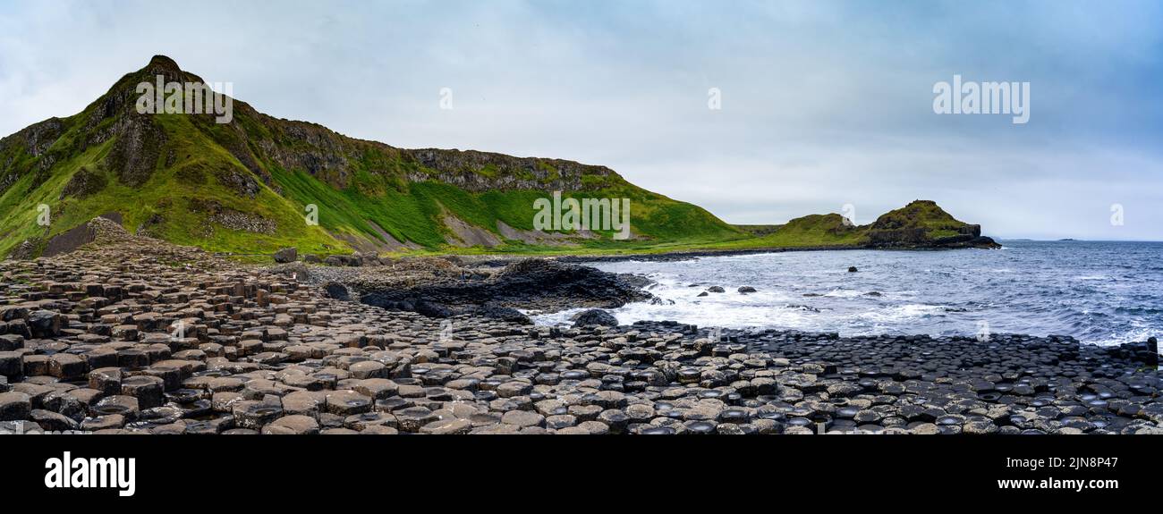 A panorama landscape view of the many volcanic basalt columns of the Giant's Causeway in Northern Ireland Stock Photo