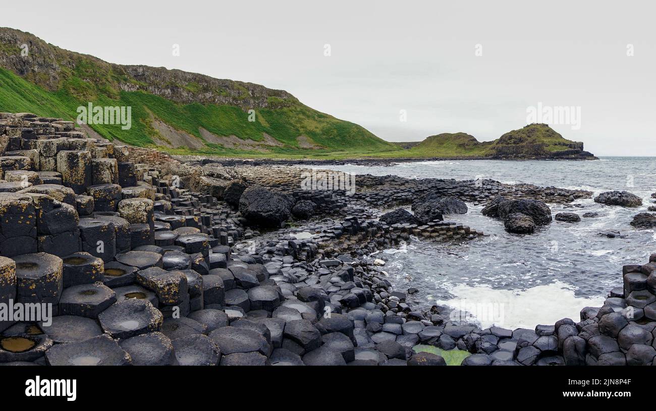 A landscape view of the many volcanic basalt columns of the Giant's Causeway in Northern Ireland Stock Photo